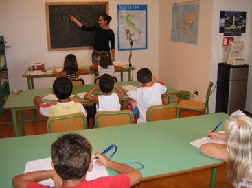 Young boy in Italian classroom with teacher