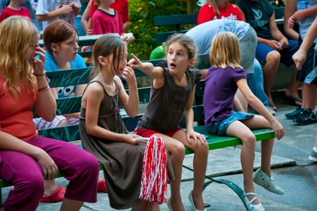 Little kids are sitting on bench